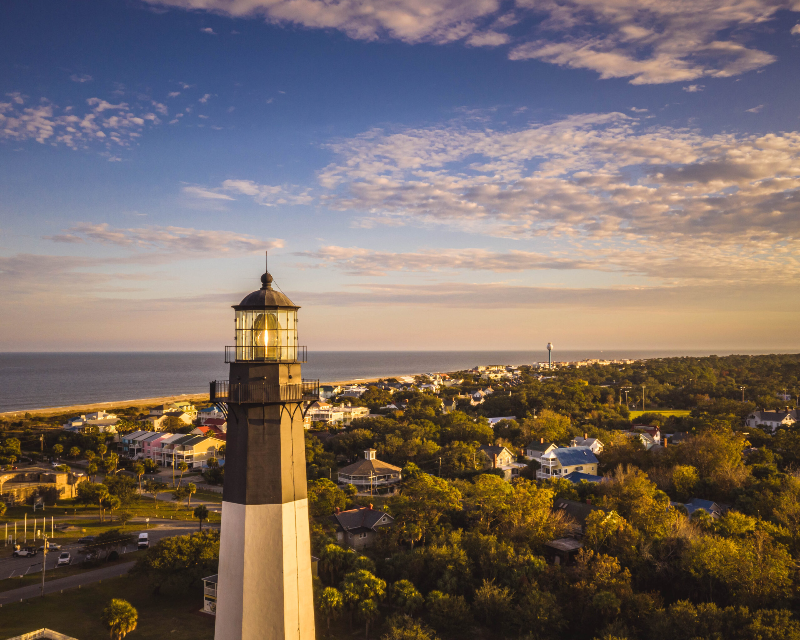 Lighthouse with coastal town in the background